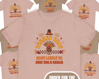 May include: A set of five pink t-shirts with a retro-style turkey design. The shirts feature the text "Turkey Trot" and "Most Likely to Stop for a Snack". The text "Order for the Whole Group!" is displayed in a brown box.