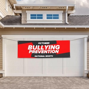 May include: A rectangular banner with the words "October Bullying Prevention National Month" in white text on a red and black background, hanging on a garage door.