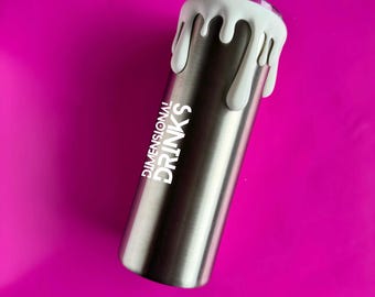 May include: A stainless steel tumbler with white dripped design around the top. The text "DIMENSIONAL DRINKS" is printed vertically in white on the side of the tumbler. The background is a solid magenta color.