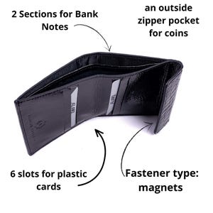 Black leather wallet with an open design, featuring two sections for bank notes, six slots for cards, and an outside zipper pocket for coins. The wallet is secured with magnets.