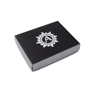 A black box with a silver rim and a white logo on the top. The logo is a sunburst design with the letter "A" in the center. The box is square and sits on a white background.
