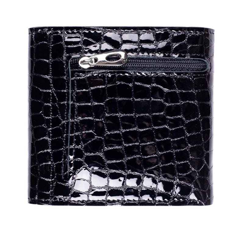 Black, textured wallet with a glossy finish. The wallet has a zipper pocket on the front and a crocodile skin pattern. The zipper pull is silver. The wallet is square and to be made of leather.