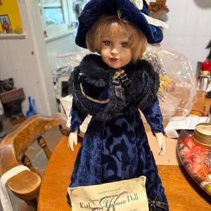 porcelain  doll beauty in royal blue, 16”