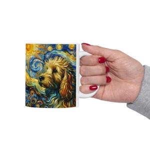 May include: White ceramic mug with a colorful abstract painting of a dog's head. The painting features swirling blue, yellow, and white colors.