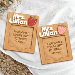 May include: Two wooden teacher appreciation plaques. Each plaque has the name "Mrs. Lillian" in white letters, a strawberry, and the text "THANK YOU FOR BEING THE BERRY BEST TEACHER! FROM, HALEY".