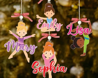 May include: Ornament set featuring cartoon gymnasts with personalized names: Mary, Emily, Lisa, and Sophia. Each ornament has a red and white ribbon bow and a white bead. The gymnasts are in various poses and wear leotards.