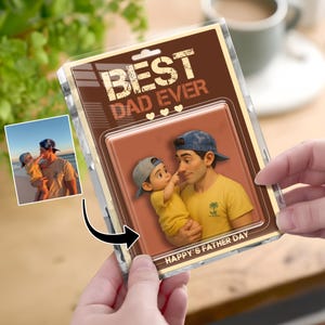 May include: A clear plastic package with a brown backing card that reads "BEST DAD EVER" in distressed white text. The card features an illustration of a father and child. The text "HAPPY'S FATHER DAY" is at the bottom.