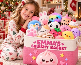 May include: A rectangular pink fabric storage basket with white trim, featuring the text EMMA'S SQUISHY BASKET in pink letters. The basket is decorated with a large smiling dumpling graphic, hearts, and stars, and is filled with various colorful plush toys.