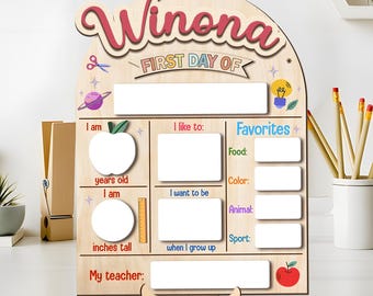 May include: Wooden first day of school sign for Winona. The sign has spaces to fill in information about the student's age, height, favorites, and teacher. The sign is decorated with a red apple, a lightbulb, and a red apple.