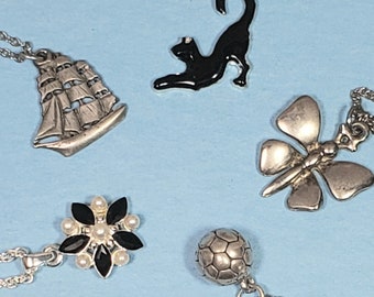 Lot of five silver tone pendant necklaces ball cat butterfly flower ship