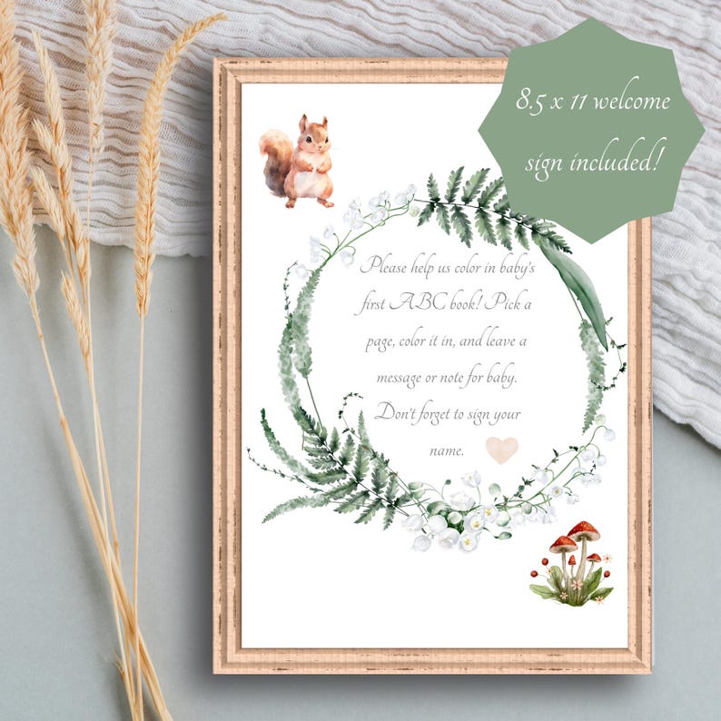Peut inclure: Un panneau de bienvenue encadr&eacute; de 21,6 x 27,9 cm avec un design &agrave; l'aquarelle. Le panneau pr&eacute;sente un &eacute;cureuil, une couronne florale et un texte qui dit : "Aidez-nous &agrave; colorier le premier livre ABC de b&eacute;b&eacute; !" Le panneau est dans un cadre en bois.