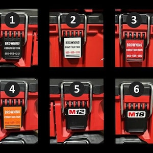 May include: Six red toolboxes with different labels. The labels include numbers 1 through 6, the text "Browning Construction" with a phone number, and the text "M12" and "M18".