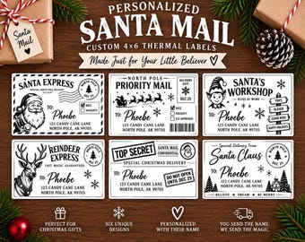May include: Six rectangular white thermal labels with black ink designs featuring Christmas themes. Each label includes the text 'Phoebe', '123 Candy Cane Lane', and 'North Pole, AK 99705'. Designs include Santa, reindeer, elves, and 'Top Secret' stamps.