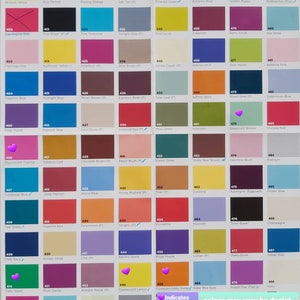 May include: A colour swatch chart featuring a grid of numerous small squares, each displaying a unique colour with a corresponding numerical code and name. The chart includes a legend noting that purple heart icons indicate fluorescent colours that glow under UV light.
