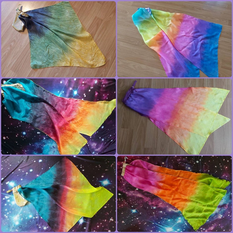 May include: A collection of six dance flags featuring lightweight, semi-sheer fabric in vibrant gradient colourways including teal, magenta, yellow, orange, and purple. Each flag is attached to a small, rectangular, metallic-gold fabric weight.