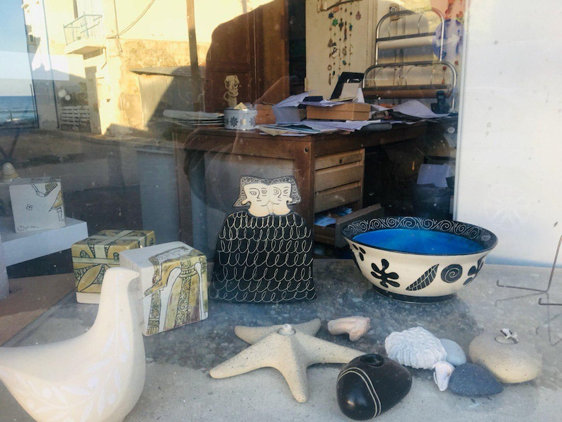 a window display of sea shells and other items