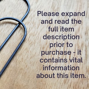 May include: Text on a wooden surface that reads: "Please expand and read the full item description prior to purchase - it contains vital information about this item."