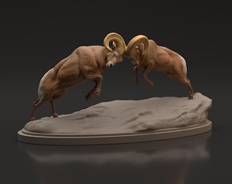 May include: A sculpture depicting two bighorn sheep in a head-butting pose. The rams are brown with cream-colored markings and large, curved, golden horns. The sculpture is mounted on a light brown, oval-shaped base.