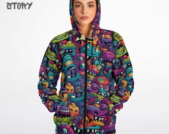 Puede incluir: Una sudadera con capucha negra con cremallera con un estampado colorido de monstruos de dibujos animados en toda la superficie. El estampado presenta una variedad de colores, incluyendo morado, verde, azul, amarillo y naranja.