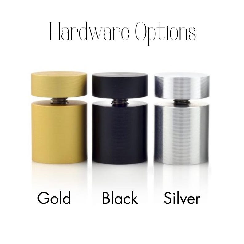 Op de afbeelding: Drie metalen displaystandaards in goud, zwart en zilver. Hardware-opties.