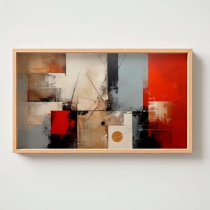 Puede incluir: Impresión artística abstracta en un marco de madera clara. La obra presenta una composición geométrica de bloques rojos, negros, beige, blancos y grises con líneas que se cruzan y un elemento de diseño circular. La estética general es moderna y minimalista.