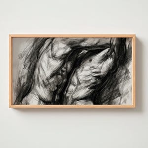 May include: A charcoal drawing of a torso in a light wood frame. The artwork is a study in shadow and light, with bold strokes defining the form. The piece is a monochromatic study of the human form.
