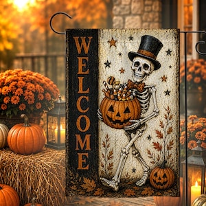 May include: A rectangular garden flag featuring a skeleton wearing a top hat and bowtie, holding a jack-o'-lantern filled with candy. The word WELCOME is printed vertically in orange on a black side panel. The background includes stars and leaves.