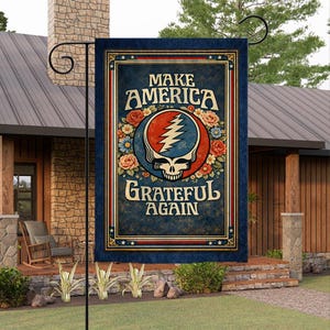 May include: A rectangular garden flag with the text "MAKE AMERICA GRATEFUL AGAIN" in white lettering. The flag features a skull with a lightning bolt, surrounded by flowers in a blue and red circle. The flag has a dark blue border.