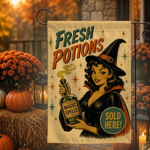 May include: A rectangular garden flag featuring a vintage-style illustration of a witch holding a green potion bottle. The text reads FRESH POTIONS, MAGIC SPELLS, and SOLD HERE! The design includes star accents on a cream-colored background.