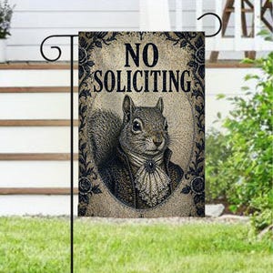 May include: A garden flag with a vintage design. The flag features a detailed illustration of a squirrel dressed in formal attire, with the words "NO SOLICITING" at the top. The flag is framed with floral elements.