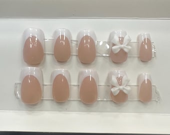 white bow nails. handmade press ons. gel with glossy finish. french tip.