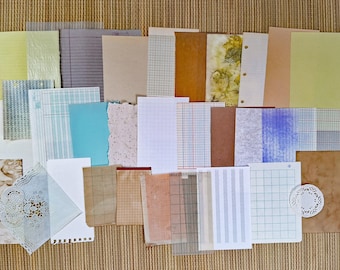May include: A collection of assorted paper sheets featuring various textures, colors, and patterns including grid, lined, solid, and botanical prints. The set includes rectangular papers, a small circular white paper doily, and translucent vellum.