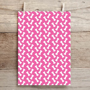 May include: Pink wrapping paper with a white bone pattern.