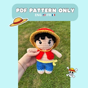 May include: Crochet pattern for a plush toy of a cartoon character wearing a straw hat, red vest, blue pants, and a yellow belt. The pattern is available in English and French.