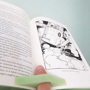 May include: A black and white illustration of a wooden horse falling from the sky. The horse is falling headfirst, with its legs outstretched. The horse is surrounded by clouds. The text "THE WOODEN HORSE WAS CARELESS" is printed below the image.