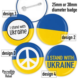May include: Four different designs for 25mm or 38mm diameter badges featuring the Ukrainian flag colours of blue and yellow. The designs include a peace sign, the text "I stand with Ukraine", and a simple split of the blue and yellow colours.
