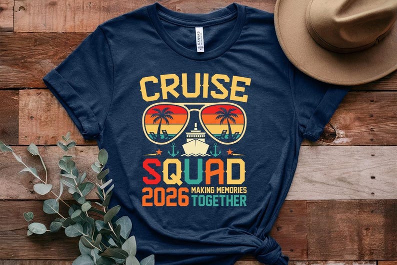 May include: Navy blue t-shirt with a graphic design featuring the words "CRUISE SQUAD 2026" in yellow, orange, and red. The design includes sunglasses with palm trees, a cruise ship, and the phrase "MAKING MEMORIES TOGETHER."