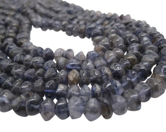 May include: A strand of dark blue, faceted, teardrop-shaped gemstone beads. The beads are smooth and polished, with a slight shimmer.