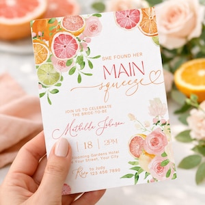 May include: A bridal shower invitation with a watercolour design featuring citrus fruits and floral accents. The invitation reads "She Found Her Main Squeeze" in elegant script. Details include the bride's name, date, time, and location.