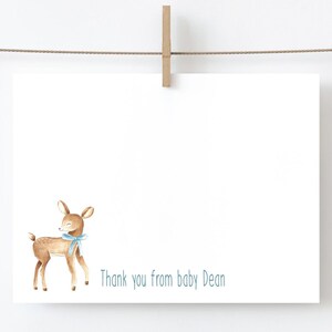 May include: A white card with a brown deer with a blue bow. The text "Thank you from baby Dean" is printed on the card.