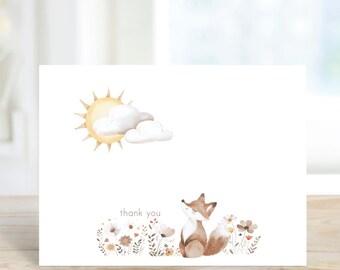 May include: A white thank you card with a watercolor illustration of a fox in a field of flowers. The sun and clouds are in the upper left corner. The text "thank you" is printed in the center of the card.