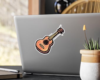 Pode incluir: Um autocolante com uma ilustração de ukulele com efeito de aguarela. O ukulele é laranja e castanho com o texto "ANY REQUESTS?" em preto. O autocolante está num portátil.