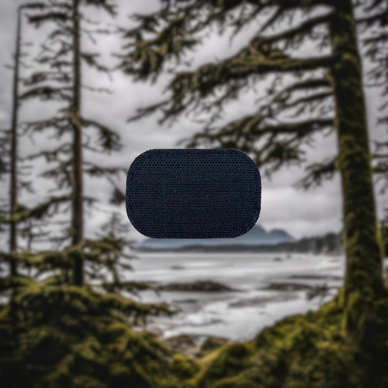 May include: A black, rectangular patch with a textured surface. The patch is made of a durable material and is suitable for use on clothing or bags.