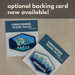 May include: Two embroidered travel patches, one with a mountain scene and the text "BARFF" and the other with a cityscape and the text "VANCOUVER". Both patches are on white cards with the text "EMBROIDERED TRAVEL PATCH by wildandwilly".