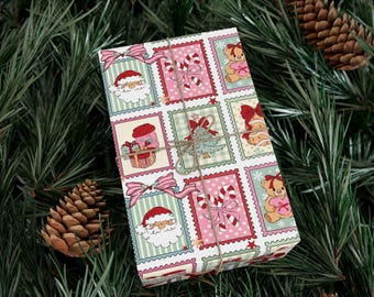 May include: A wrapped gift with festive Christmas-themed wrapping paper. The paper features a repeating pattern of Santa Claus, teddy bears, candy canes, and Christmas trees in pink, green, and red. The gift is tied with twine and set on a bed of pine needles.