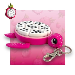 May include: Pink dragon fruit turtle keyring with a silver clip. The turtle's shell is made of white plastic with black dots and the turtle's head and legs are pink.