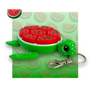 May include: A green turtle keyring with a watermelon shell. The turtle has a cute face and white polka dots. The watermelon shell is made of red and green plastic and has a realistic texture.