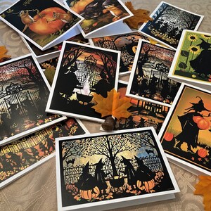 May include: A collection of Halloween-themed greeting cards featuring black silhouettes of witches, cats, and pumpkins against colorful backgrounds. The cards are perfect for sending spooky greetings to friends and family.