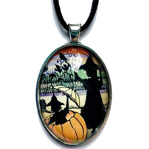 May include: A black glass pendant necklace with a black cat silhouette and a pumpkin on a colorful background. The necklace has a black cord.