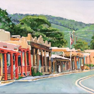 May include: A painting of a street scene in a small town with adobe buildings, a flagpole with an American flag, and a winding road.